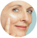 A woman applying cream to her face