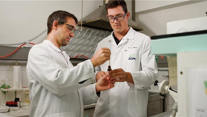 two scientists in a lab with eyedroppers