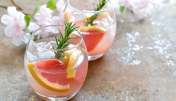 two glasses of a fruity and floral drink