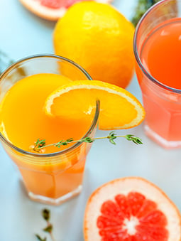 two glasses of orange juice or grapefruit juice