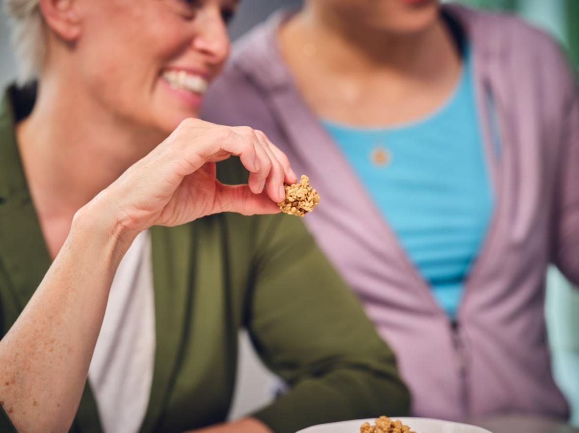 Woman holding granola at breakfast