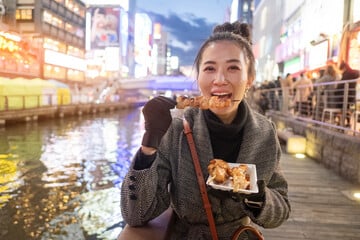 Woman eating exotic food in a street