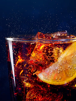 Refreshing cola beverage with citrus slice